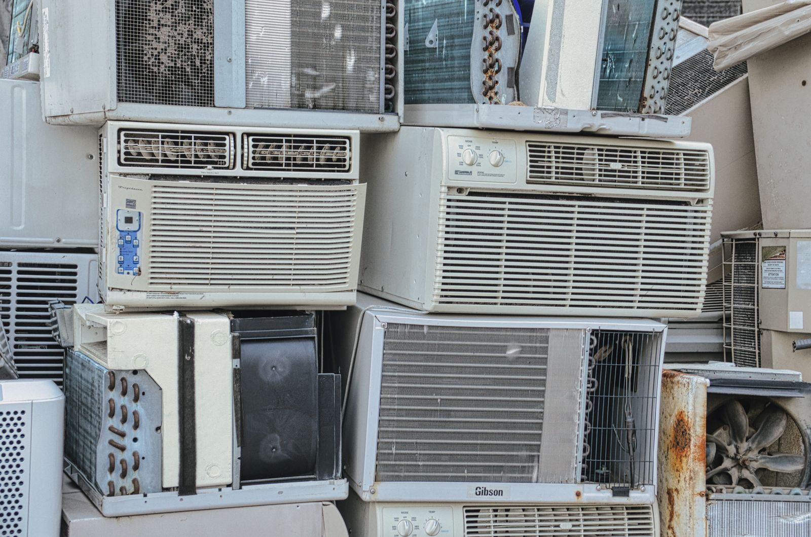 A heap of old window air conditioners cleared for recycling