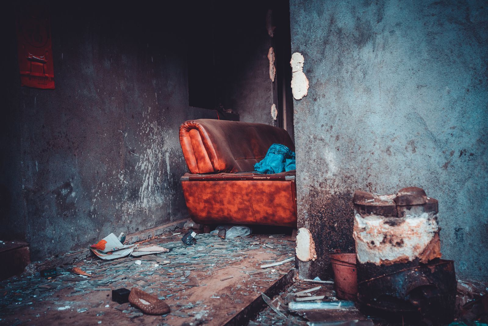 A sagging sofa left behind in an empty room