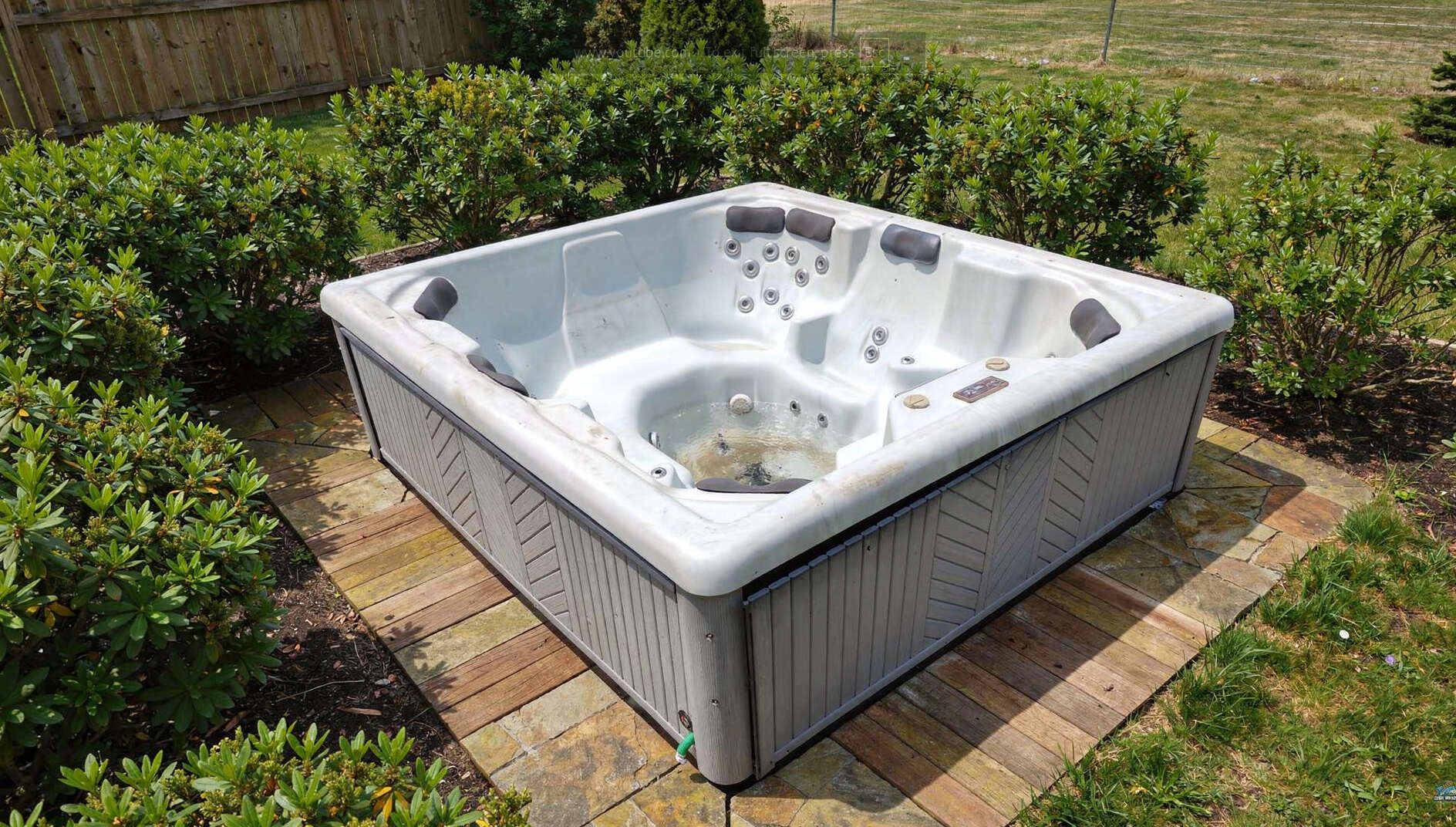 A spa sitting on a backyard patio